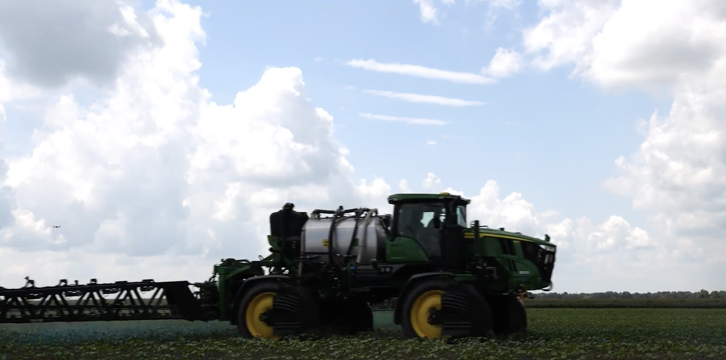 The 412R John Deere See & Spray Ultimate sprays water, dyed blue, in a demonstration of the sprayer distinguishing weeds from crops, in Keiser, Ark.